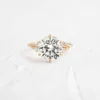 Round cut sterling silver engagement ring with sparkling pave side stones