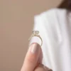Sterling silver ring with 2 MM side stones and pave detail