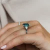 Gold-plated sterling silver ring featuring an emerald-green centre stone