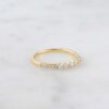 Minimal ring featuring five sparkling stone settings