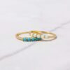 Gold-plated ring with pavé-style stones around turquoise accents