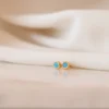 Turquoise stud earrings accented with sparkling cubic zirconia details