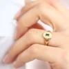 Elegant signet ring with polished silver and vibrant green CZ stone