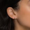 Hypoallergenic huggie earrings in sterling silver with black CZ stones