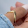 Minimal chevron band paired with a pavé ring