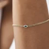 Curb link bracelet with emerald accents and gold plating