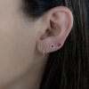 Flower stud earrings available with sapphire, emerald, or ruby stones