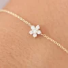 Gold-plated silver bracelet featuring a sparkling flower charm