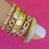 Domed ring finished in thick gold plating and CZ stones