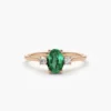 Silver ring featuring a balanced emerald and diamond arrangement