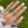 Classic ring with continuous emerald-style stones