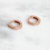 Small hoop earrings with a subtle geometric texture