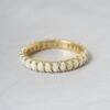 Opal eternity ring with continuous stone setting