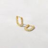 Oval huggies earrings with a slim modern silhouette