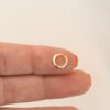 Plain huggies earrings featuring a snug, rounded hoop shape