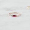 Dainty ring design with a baguette-style ruby centre stone
