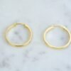 Small flat hoop earrings in three sizes for subtle everyday wear