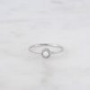 Solitaire opal ring with a CZ halo setting