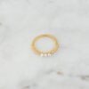 Delicate ring design with three pearls and polished finish
