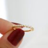 Pavé-set silver ring finished with three small pearls