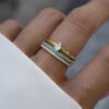 Eternity ring featuring lab created turquoise stones and a continuous setting