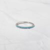 Turquoise eternity ring with a slim, continuous stone setting
