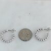 Small hoop earrings with a twisted textured design and polished finish