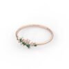 Elegant cluster ring featuring a vibrant emerald-style stone
