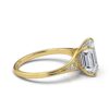 Elegant engagement ring with balanced emerald and round stone detailing