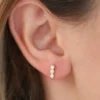 Bezel-set CZ diamond earrings in a three stone design