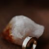 Elegant ring featuring a clean patterned band and baguette stones