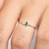 Stackable ring featuring bezel-set CZ emerald and diamond stones