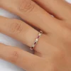 Sterling silver ring featuring bezel-set ruby and diamond-inspired stones