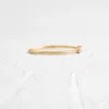 Gold-plated sterling silver ring with interlocking band design