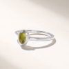 Clean sterling silver ring with a single green stone