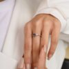Open ring featuring a prong-set blue sapphire and diamond detail