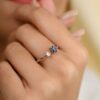 Modern open ring design with a blue sapphire accent