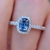 Engagement ring featuring a blue oval sapphire and sparkling CZ stones