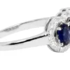Three-stone ring featuring a blue sapphire and sparkling CZ accents