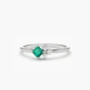 Minimal ring design highlighted by a princess-cut emerald centre stone