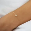 Refined bracelet with bezel-set stones along a delicate chain