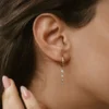Sterling silver dangling earrings with elegant, polished diamond detailing