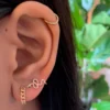 Snake stud earrings set with Premium CZ diamond and emerald stones