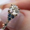 Floral engagement ring with silver finish and sapphire accents