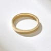 Modern ring design with a flat band and refined engraved detailing