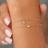 Diamond cross charm bracelet with a balanced, timeless design