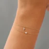 Sterling silver bracelet featuring a delicate cross charm and CZ sparkle