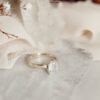 Solitaire ring with a thick four-prong emerald cut setting