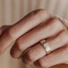 Wide cigar band ring with a simple solitaire setting