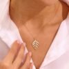 Minimalist sterling silver leaf pendant with delicate botanical detailing